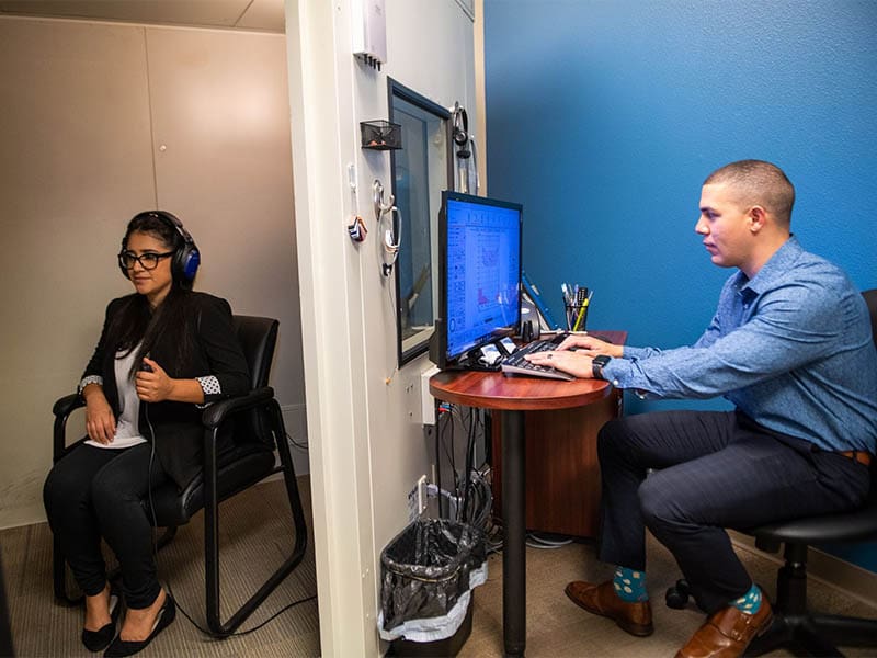 Audiologist conducting hearing test at Upstate Hearing Aid Center in Greenville